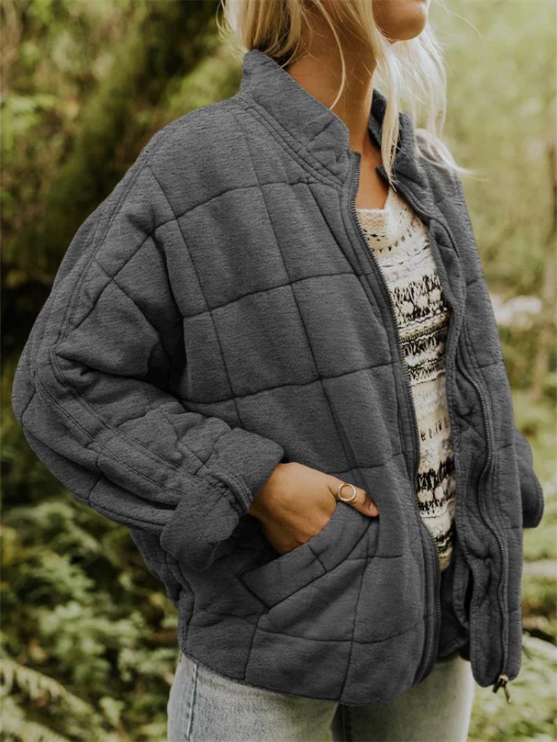 Women's stylish black quilted jacket with front zipper, perfect for fall fashion and everyday wear.