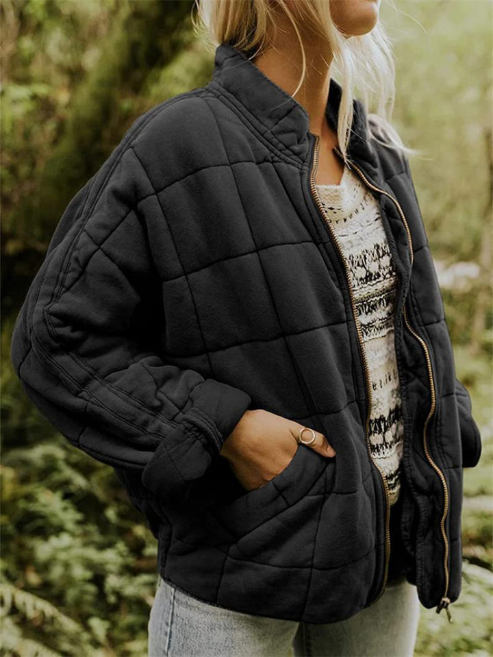 Modern women's quilted jacket featuring a functional zipper, great for a stylish look in fall and spring.