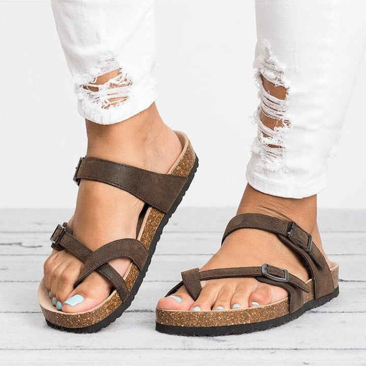 Comfortable women's toe-post flat sandals with adjustable buckle for warm weather, holidays & casual style.