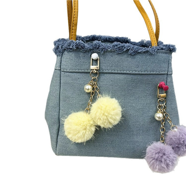 Trendy denim tote bag for women, featuring distressed frayed edges & spacious interior.