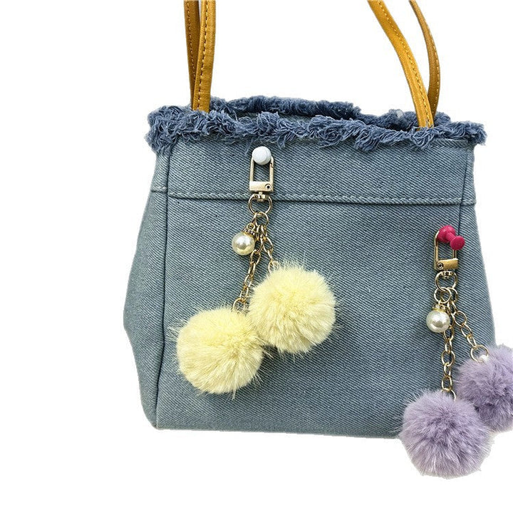 Trendy denim tote bag for women, featuring distressed frayed edges & spacious interior.