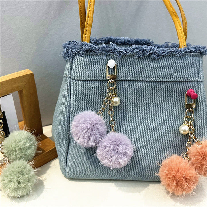 Everyday women's denim handbag with large capacity and stylish frayed edges.