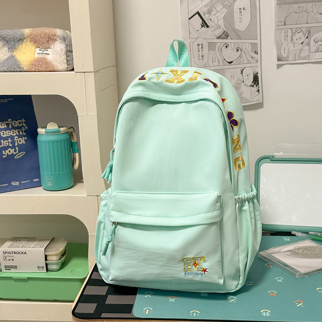 Chic women's embroidered school backpack, featuring unique colorful stitching, ideal for students & daily commute.