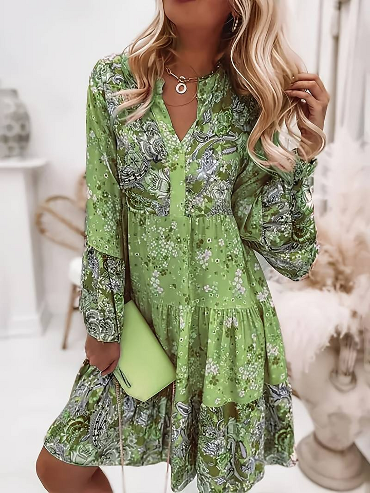 Flowy bohemian women's mini dress with a vibrant floral print, ideal for casual spring outfits.
