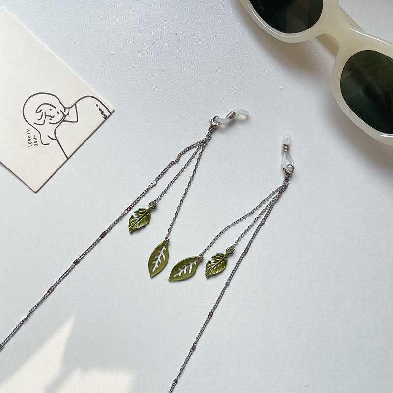 Women's stylish glasses chain holder with elegant leaf motif. Fashionable & practical eyewear accessory.