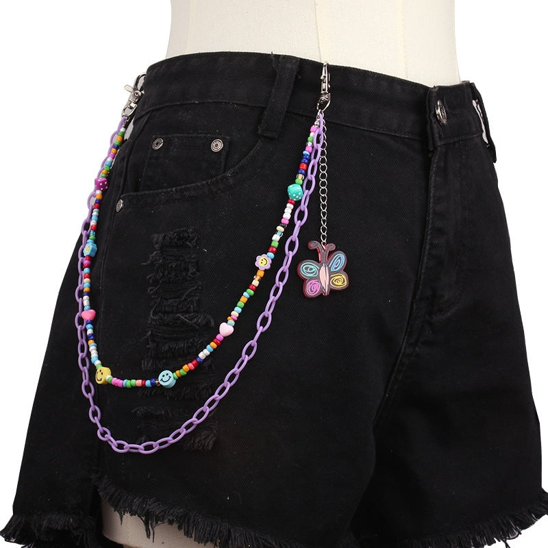 Adjustable women's gold-tone chain belt, adorned with chic beads and various charm pendants. Waist jewelry.