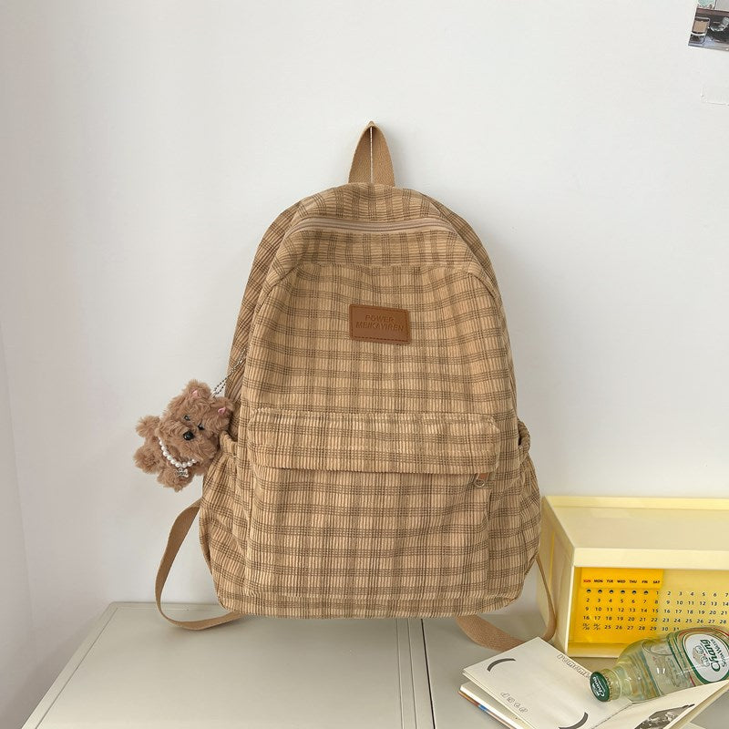 Women's stylish khaki checkered backpack, perfect for school or everyday carry. Features durable plaid fabric.