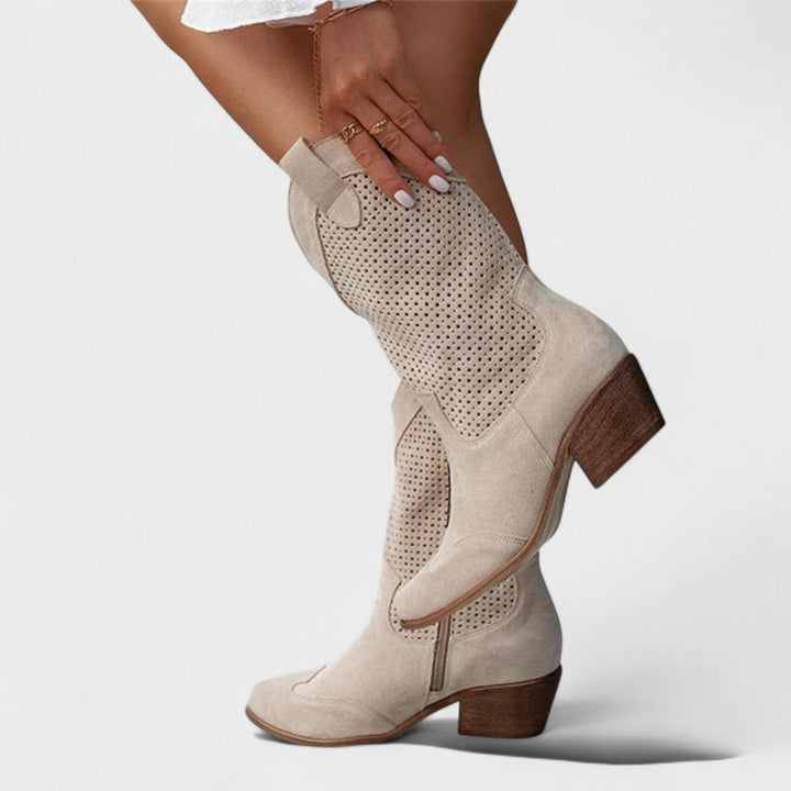 Women's stylish mid-calf boots with perforated details, block heel, and comfortable rounded toe.