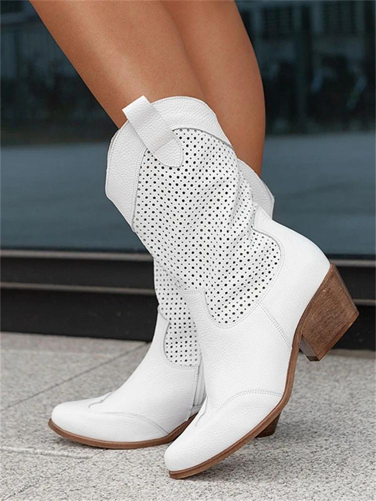 Textured shot of stylish women's mid-high western boots, emphasizing the quality material & fashion-forward design.