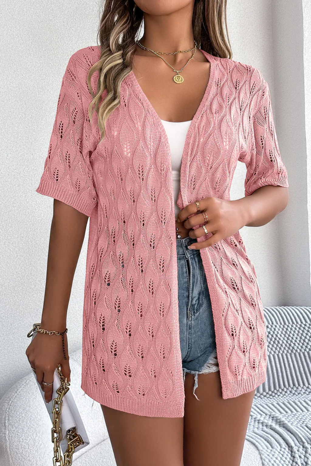 Sheer knit women's short sleeve cardigan in a light crochet design, ideal for casual summer chic.