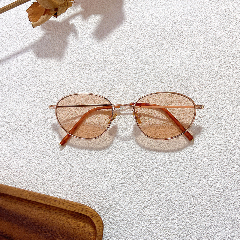 Delicate women's oval frames, a chic accessory for any outfit, offering both style and UV protection.