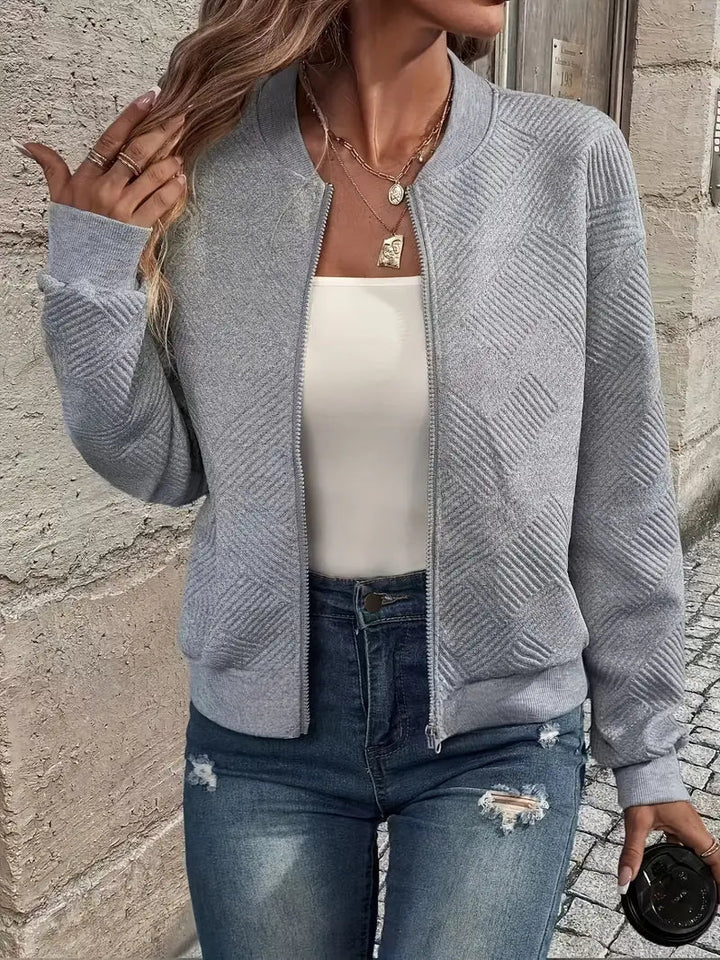 Model wearing women's stylish patterned front zip cardigan. Comfortable casual wear layering.