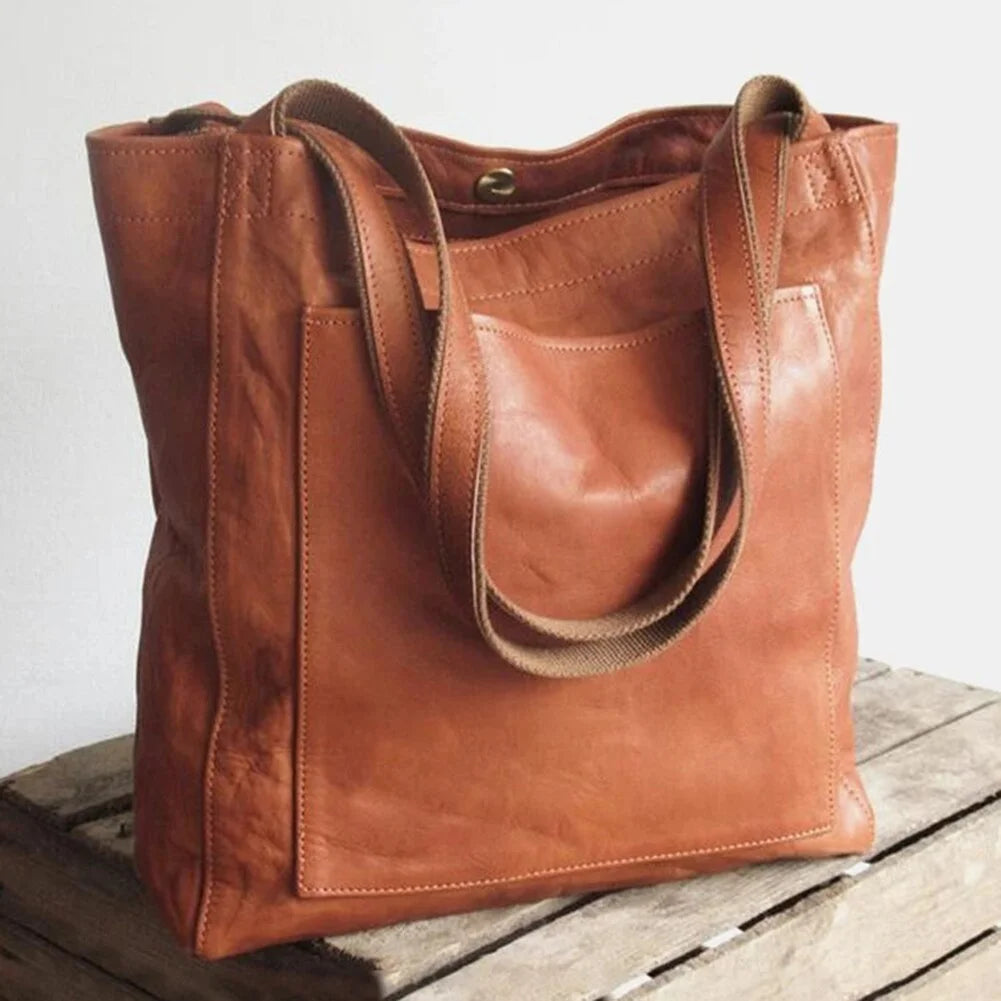 Women's stylish PU leather tote bag in dark brown with magnetic snap closure and comfortable shoulder strap.
