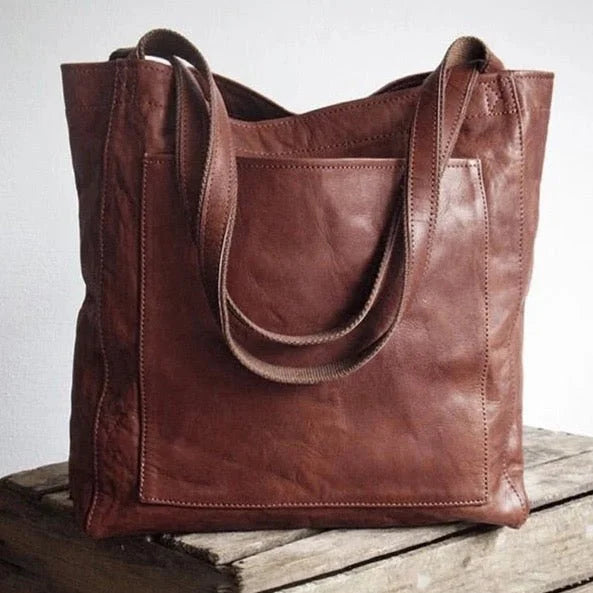 Elegant black PU leather tote bag for women, perfect for everyday use, featuring a secure magnetic closure.