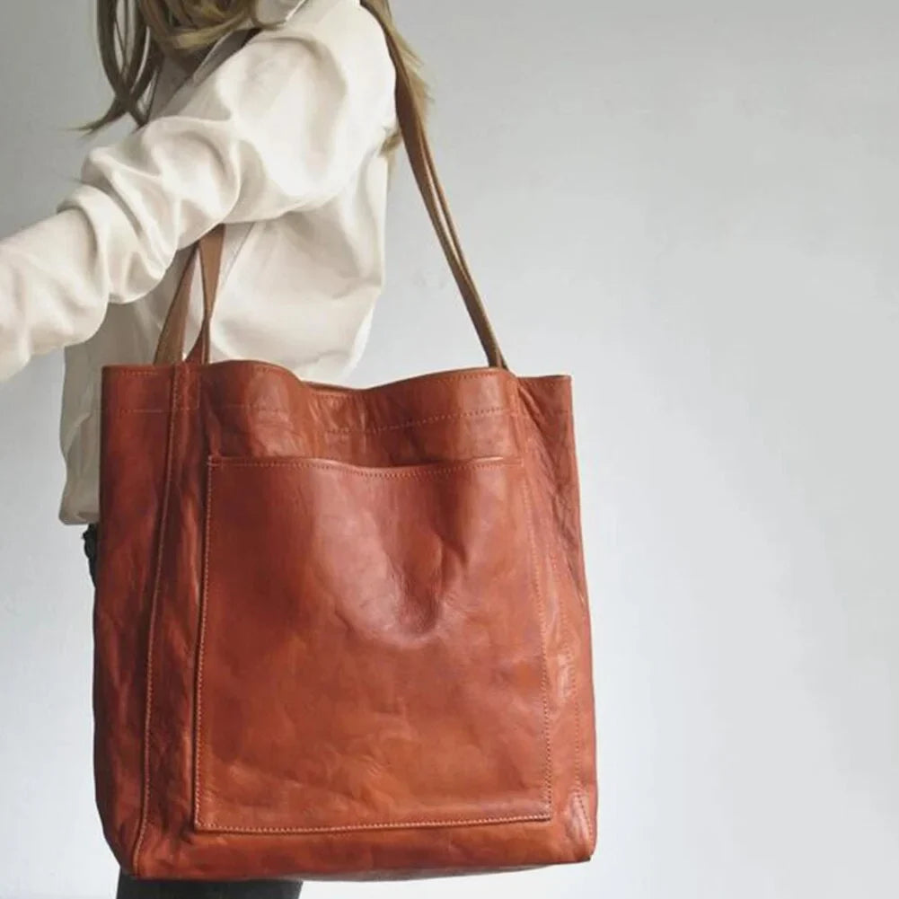 Chic PU leather handbag for women, available in black and brown, with stylish design and magnetic closure.