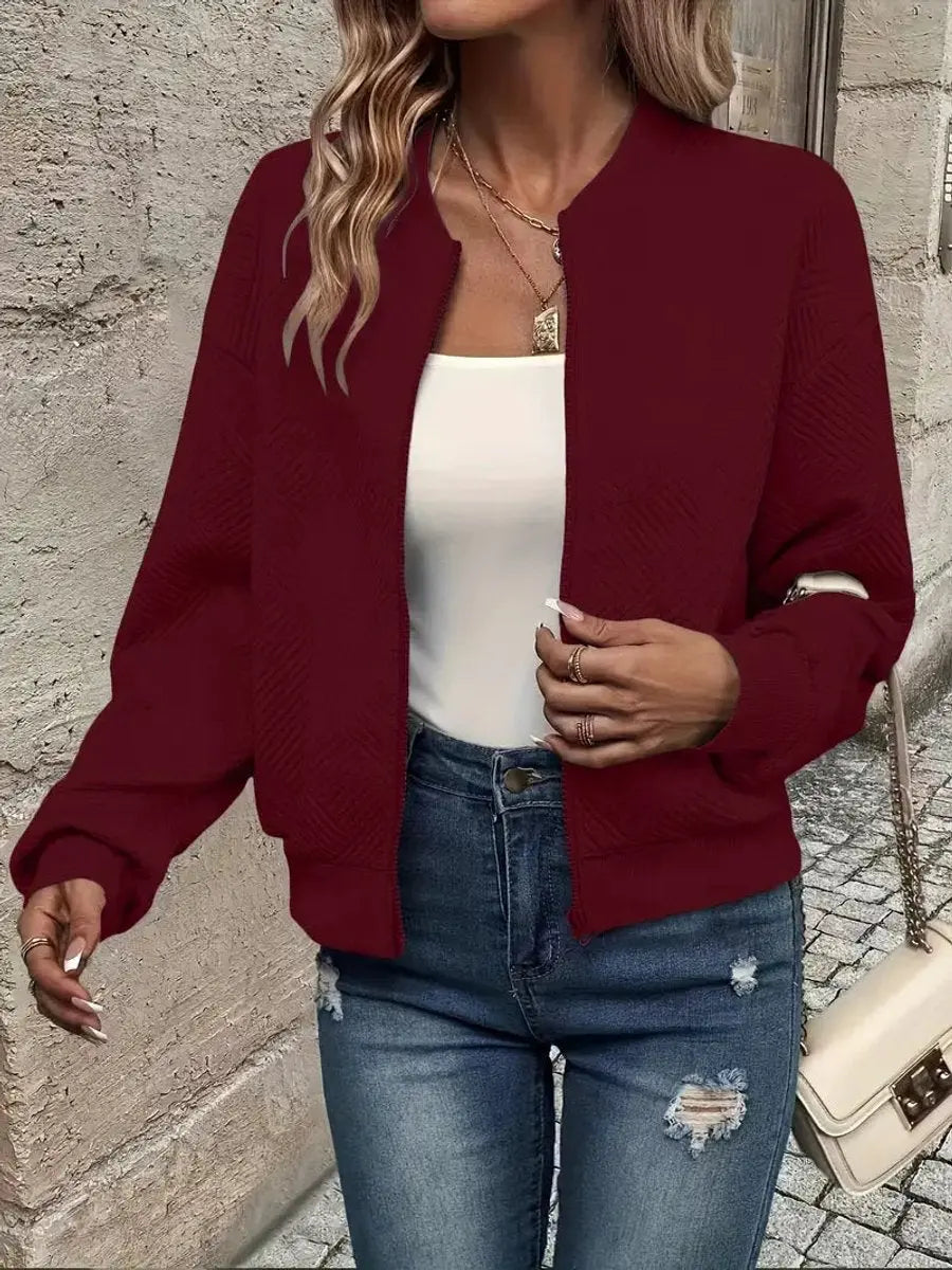Modern women's cropped quilted jacket. Stylish bomber design, full zip, excellent for spring styling.