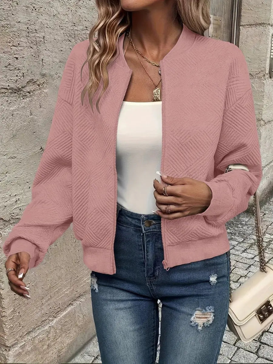Textured quilted bomber jacket for women. Cropped fit, zip-up style. Casual layering piece.