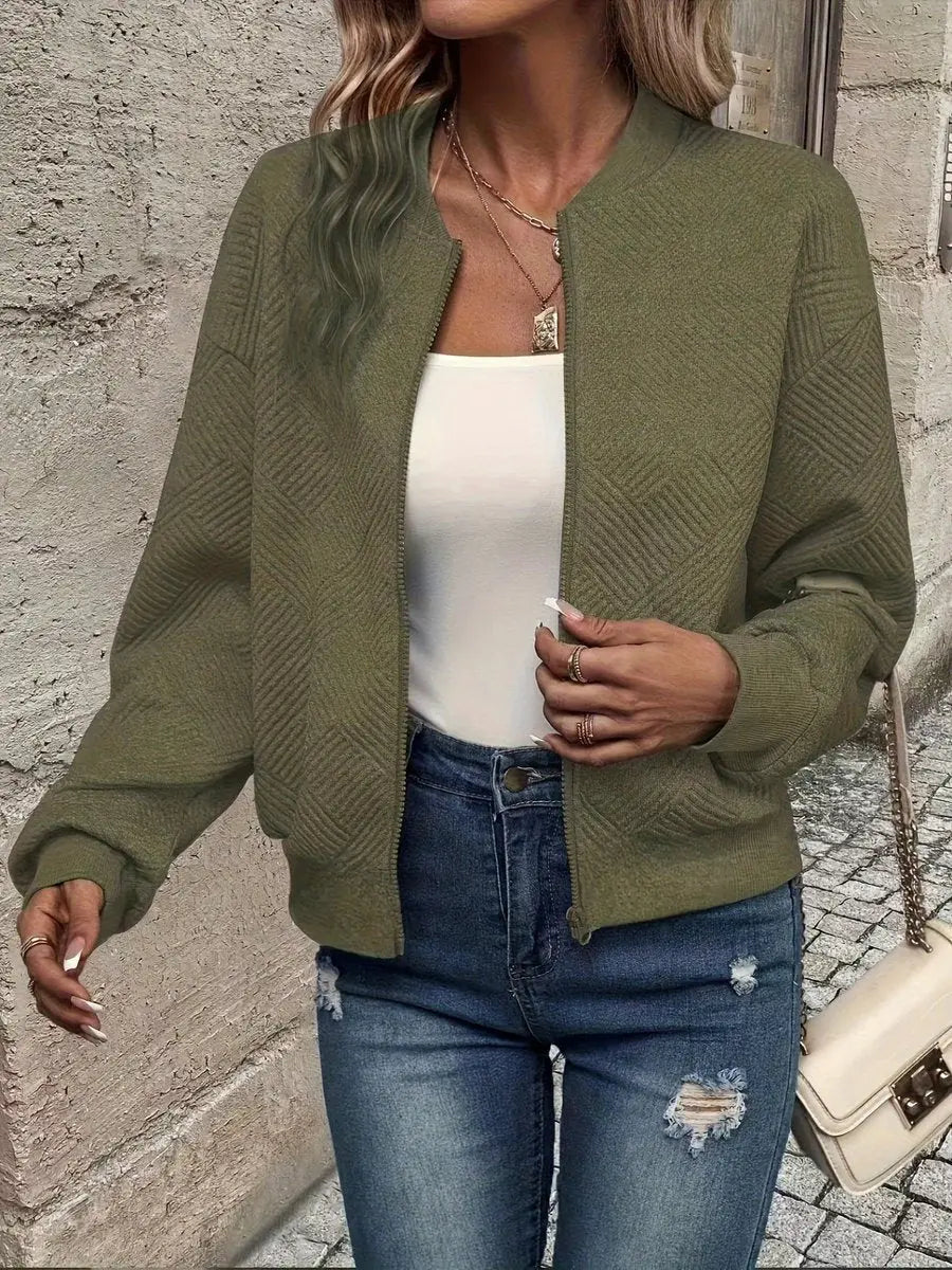 Cropped quilted bomber jacket for women. Stylish zip-up design, perfect as a fashion layering piece.