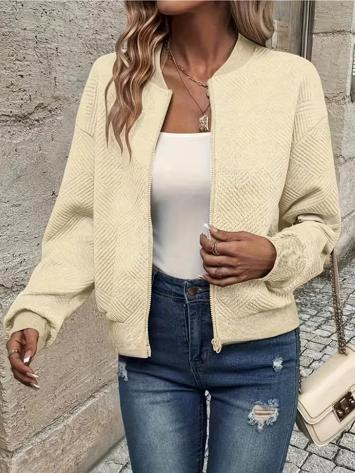 Model wearing a stylish women's cropped quilted bomber jacket. Zip-up, perfect for everyday fashion.