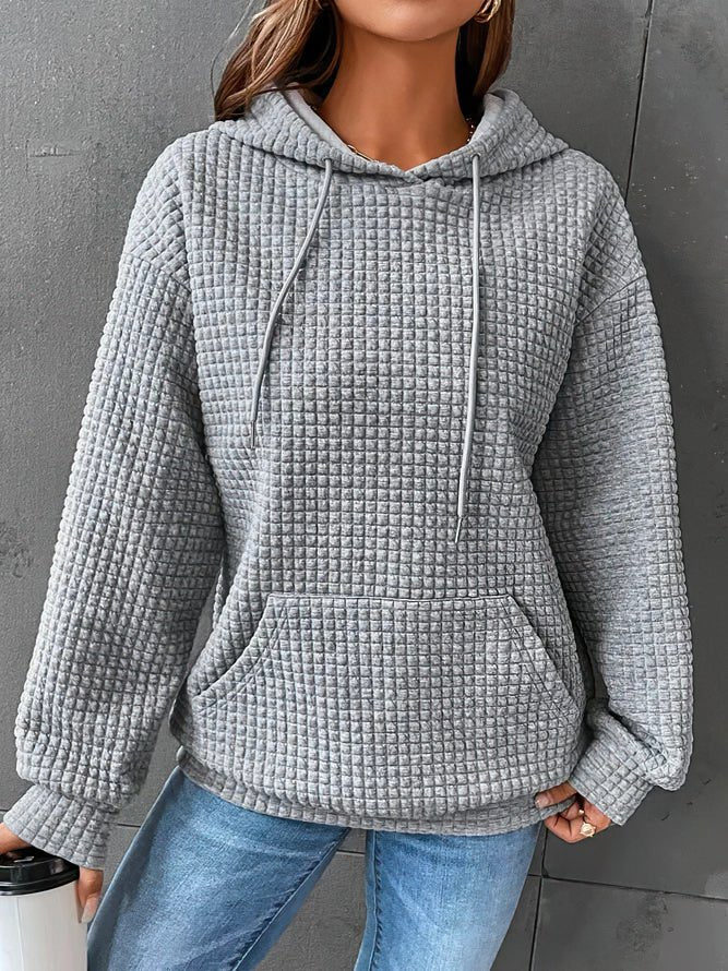 Stylish women's quilted hoodie, a fashionable long-sleeve pullover for comfortable and chic everyday wear.