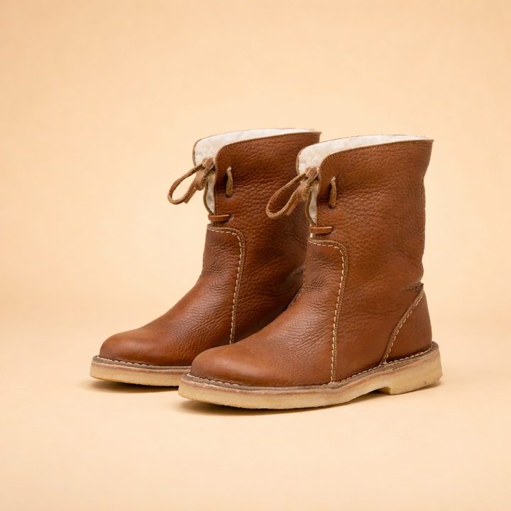 Modern stylish women's short winter boots, offering warmth & comfort. Flat heel snow footwear for cozy outdoor adventures.