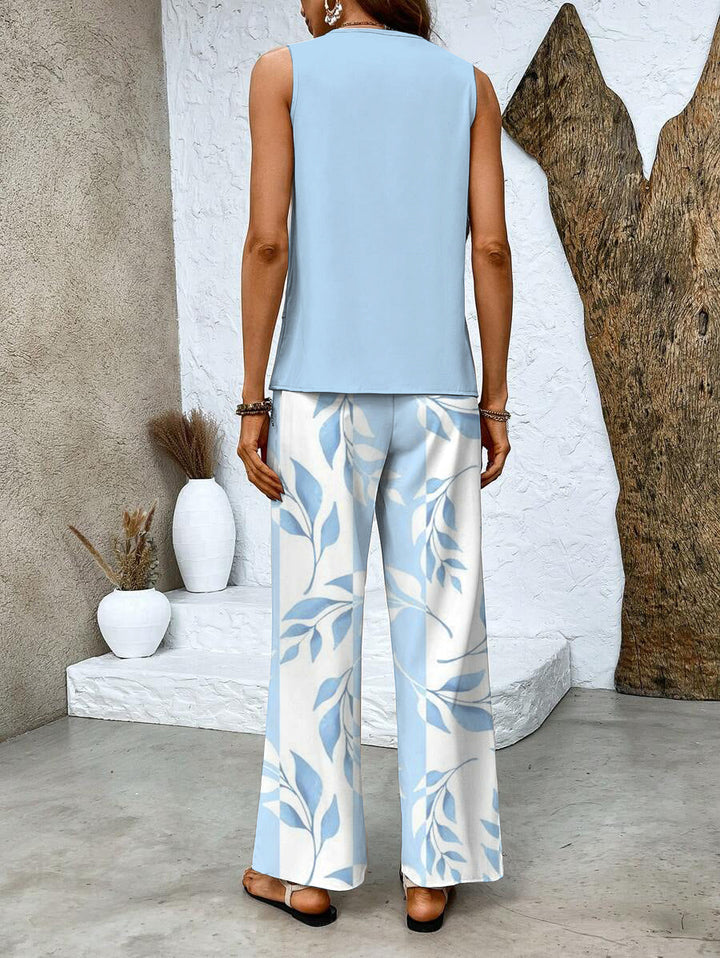 Trendy women's two-piece set, featuring a stylish sleeveless top & vibrant printed wide leg pants, casual & chic.
