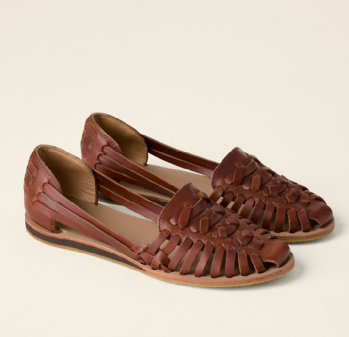 Chic women's woven flat sandals with intricate detailing, ideal for warm weather and beach outings.