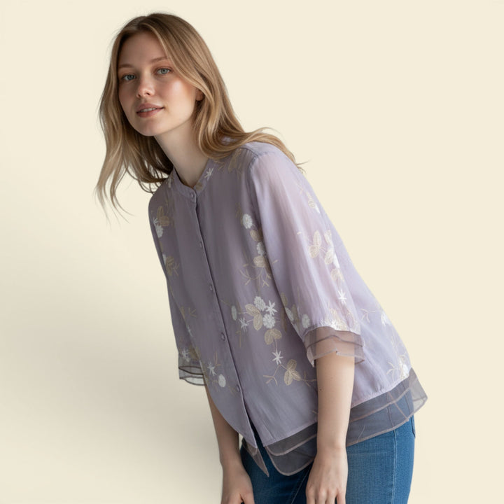 Relaxed fit women's summer top, embroidered floral pattern, button front, casual feminine fashion.