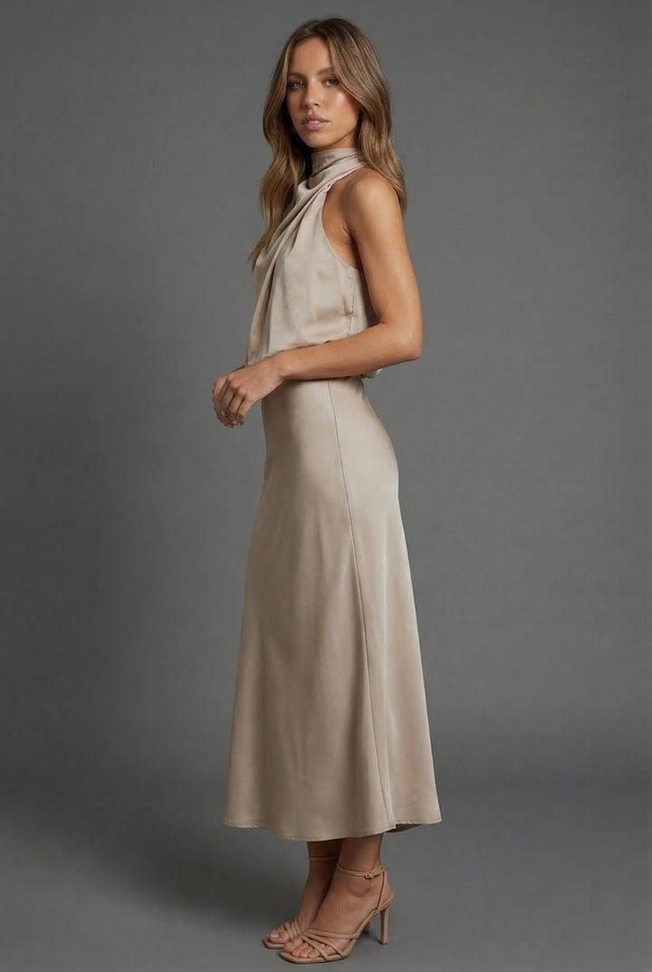 Summer wedding guest midi dress, halter neck design. Ideal for women's formal events.