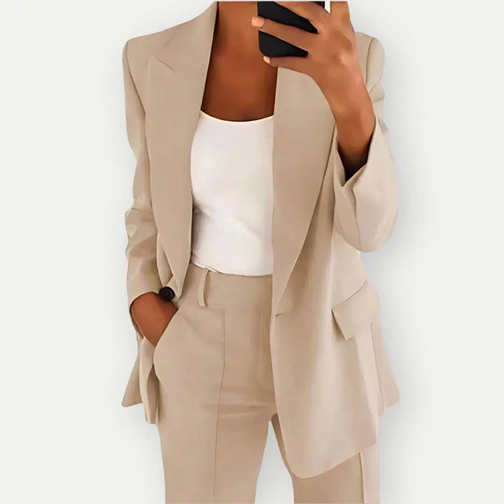 Stylish women's tailored blazer and trouser set in beige, ideal for business and formal fashion.