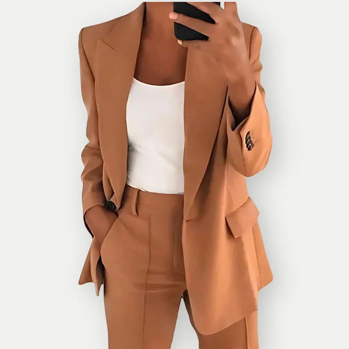 Chic women's two-piece blazer and trouser set in grey, perfect for professional elegance.