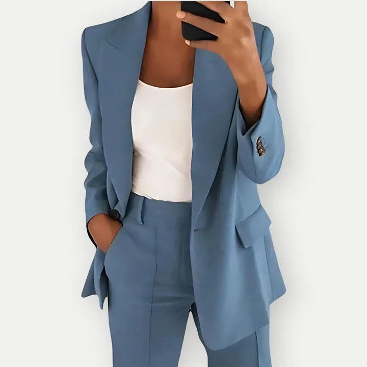 Formal women's brown tailored suit with a classic blazer and sleek trousers for office style.