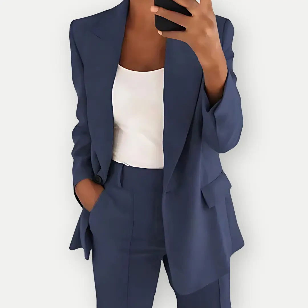 Pink women's tailored blazer and trousers set, offering a modern and professional look.