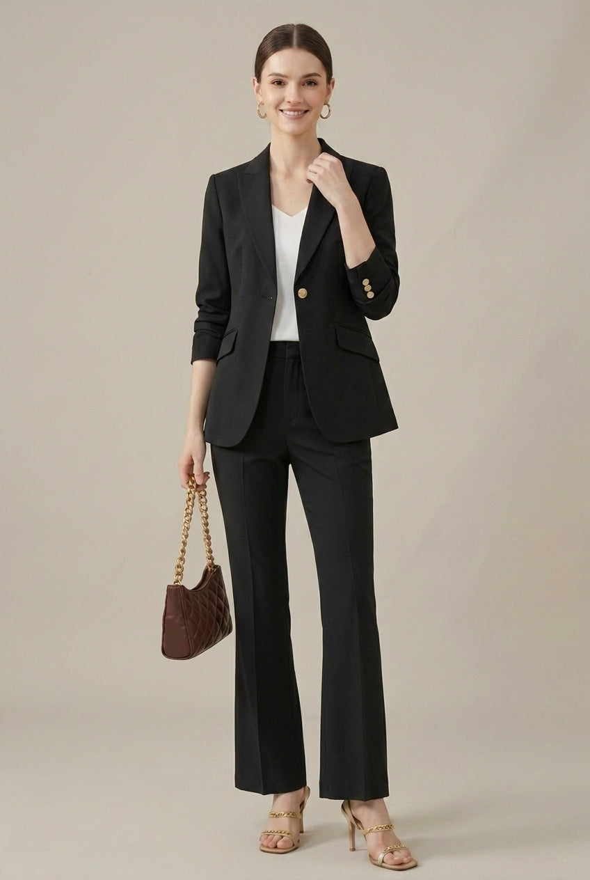 Sleek women's tailored pant suit featuring a shawl collar blazer, trousers & distinctive gold buttons.