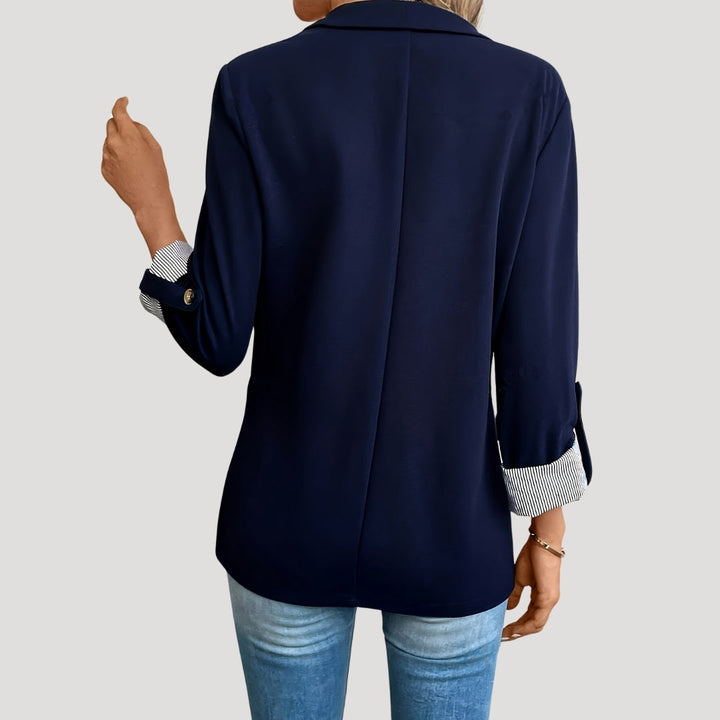 Close-up of women's tailored blazer showing stylish roll-up sleeves & lightweight fabric for summer wear.