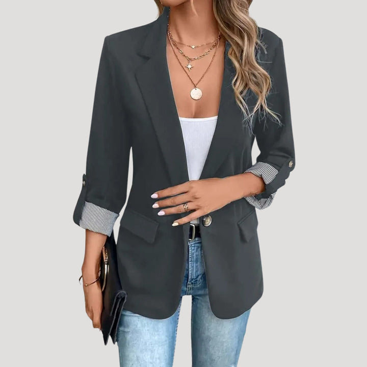 Tailored women's blazer with roll-up sleeves, single-breasted design, offering an elegant summer fit.