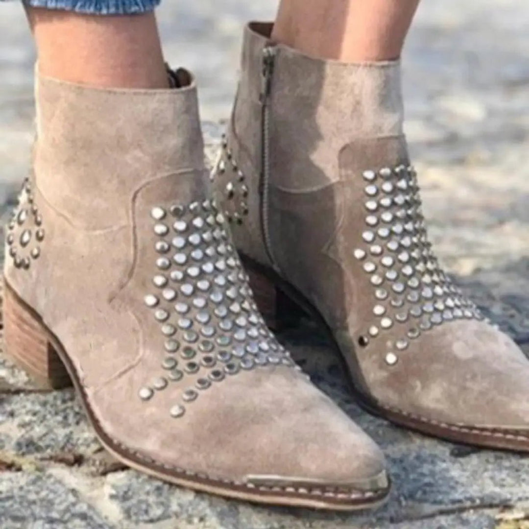Chic women's studded ankle boots with pointed toe, block heel, and convenient zip closure for fashion.
