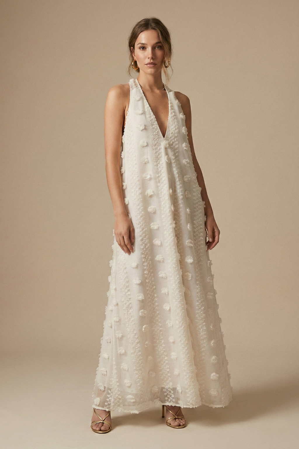 Women's textured halter backless maxi dress with delicate 3D floral appliqué, perfect for resort wear.
