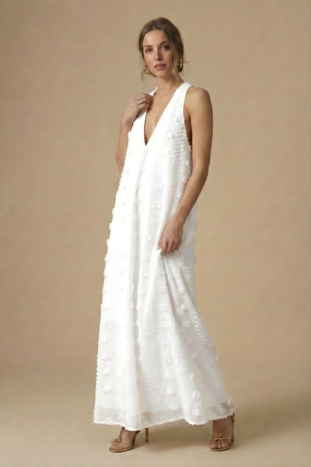 Flowing women's textured halter maxi dress with exquisite 3D floral appliqué on a backless design.