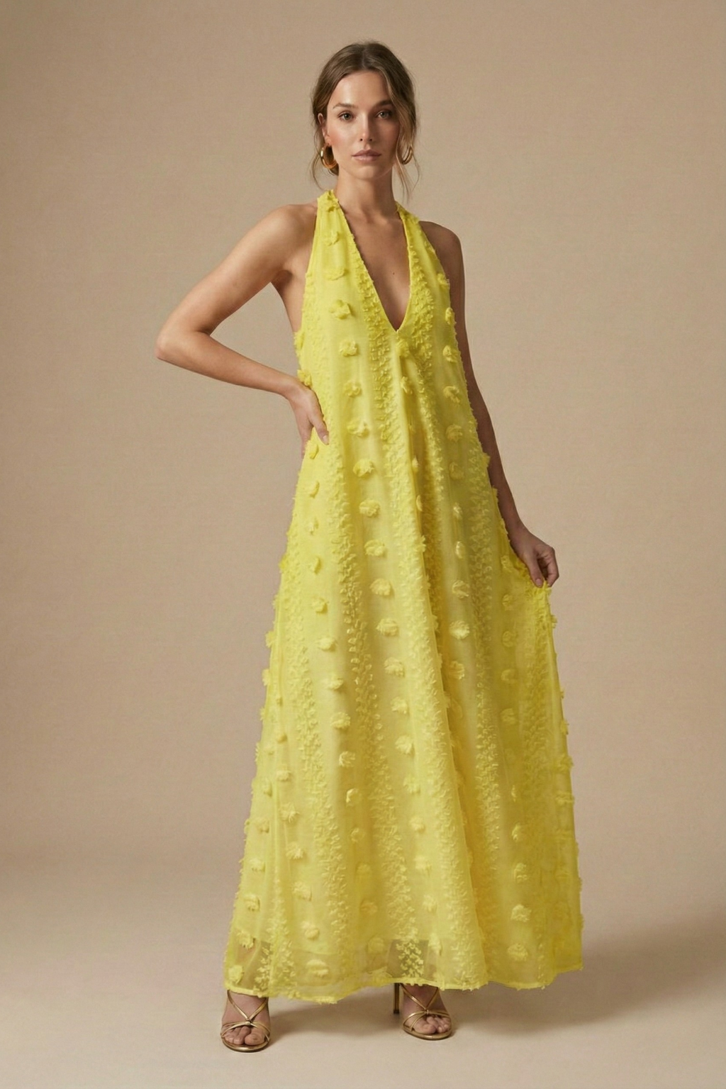 Woman's elegant summer halter maxi dress, textured fabric & backless style with eye-catching 3D floral appliqué.