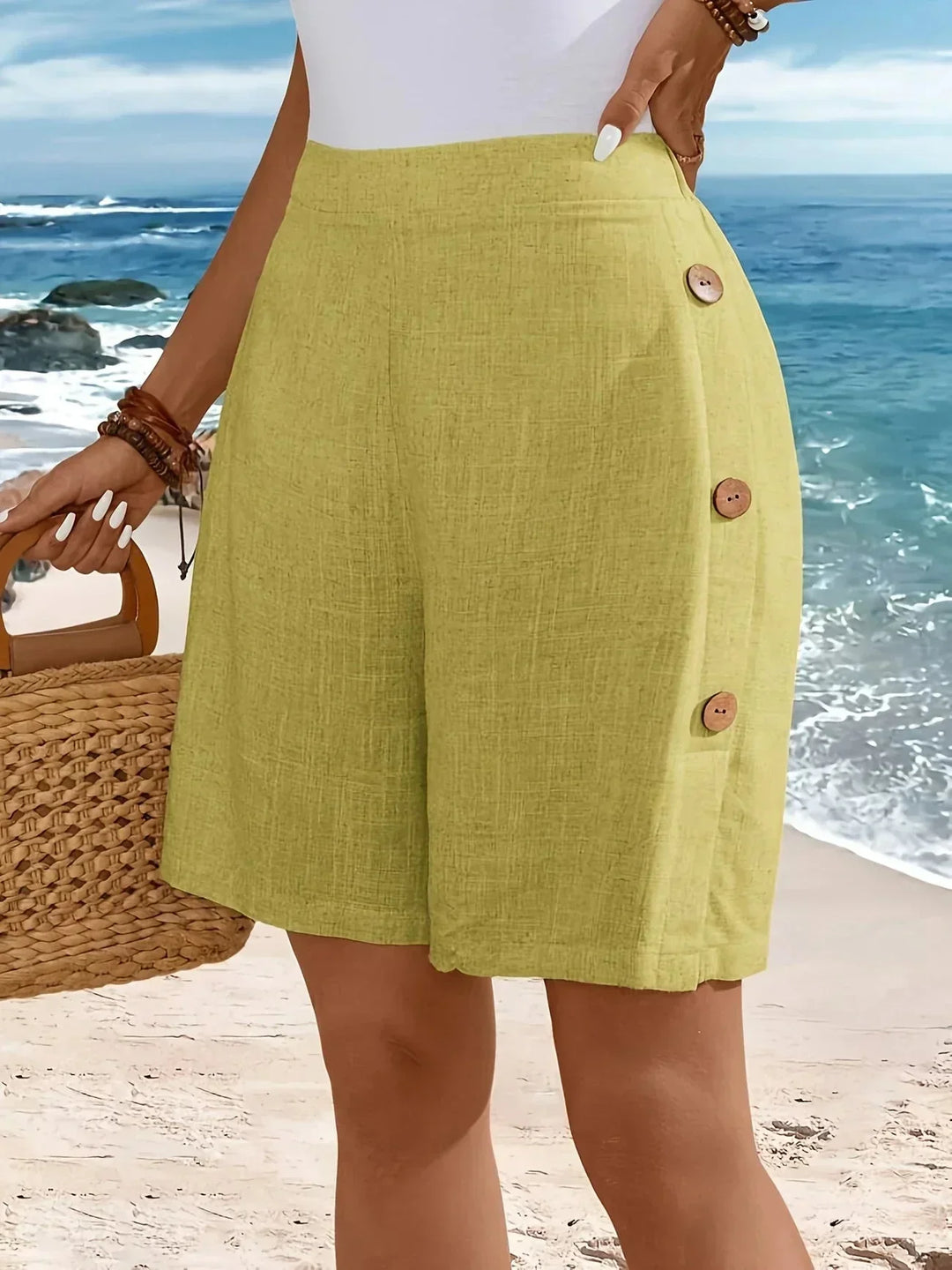 Women's textured high-waisted wide-leg shorts with stylish side buttons. Perfect for summer fashion.