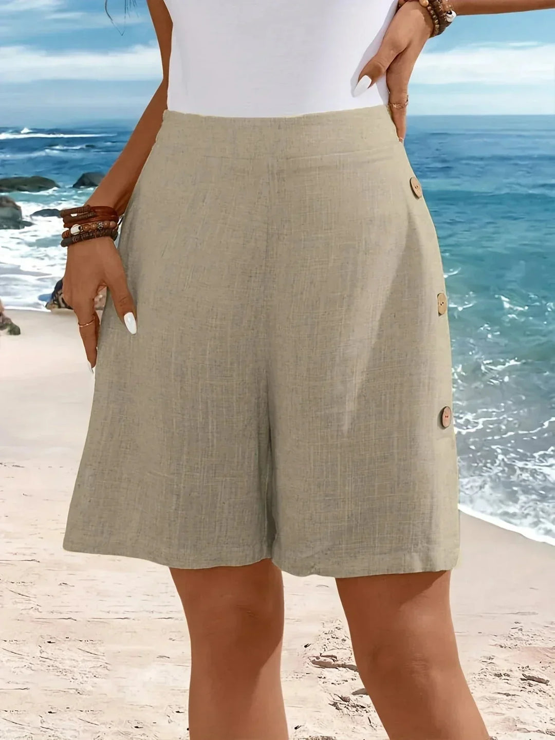 Woman in comfortable high-waisted textured wide-leg shorts with side buttons, perfect for vacation style.