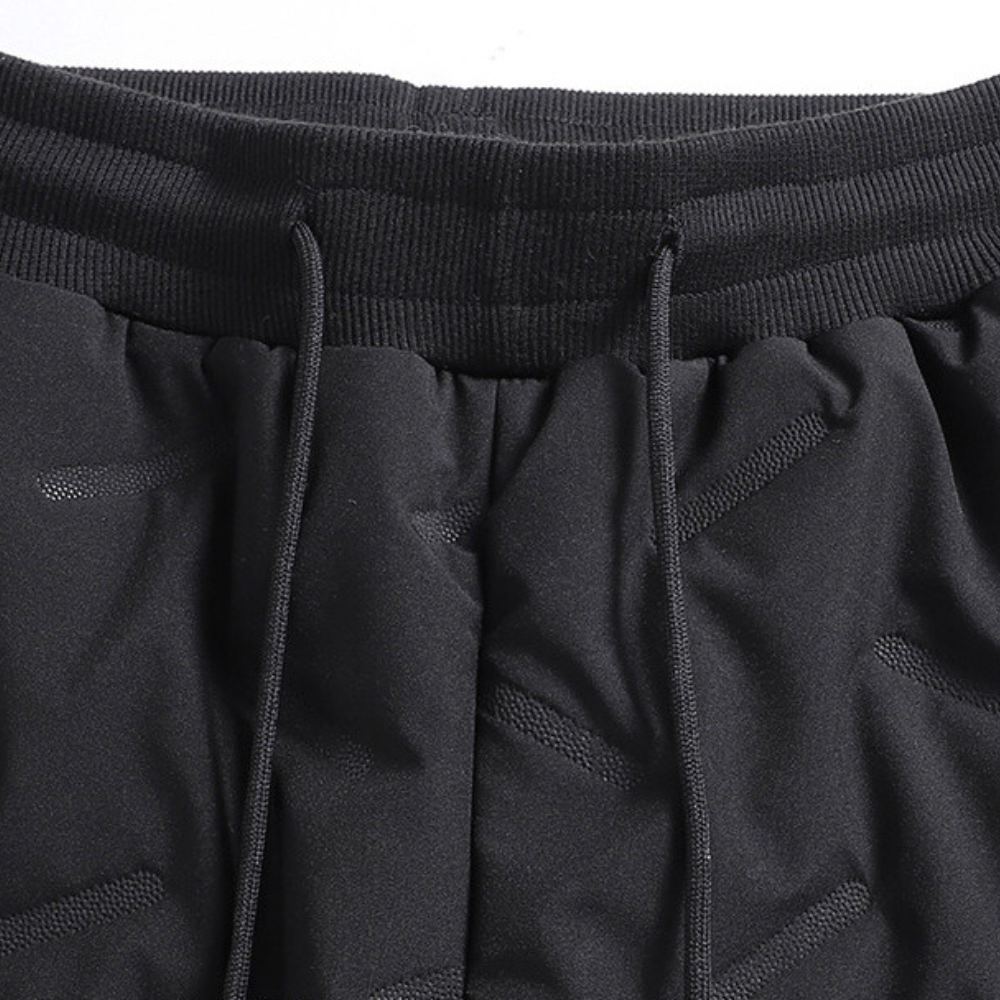 Athletic women's thermal snow pants, waterproof & insulated for skiing, hiking, and winter outdoor activities.