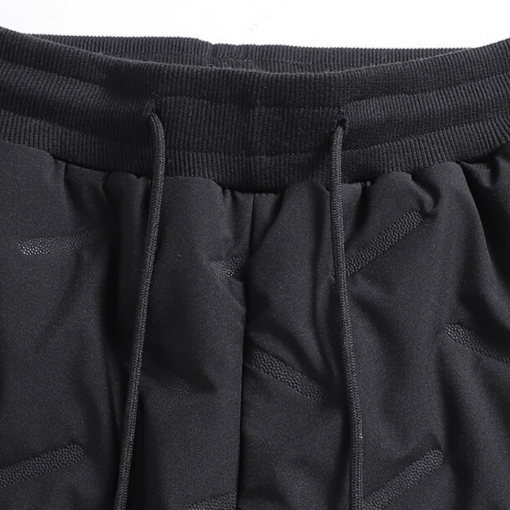 Athletic women's thermal snow pants, waterproof & insulated for skiing, hiking, and winter outdoor activities.
