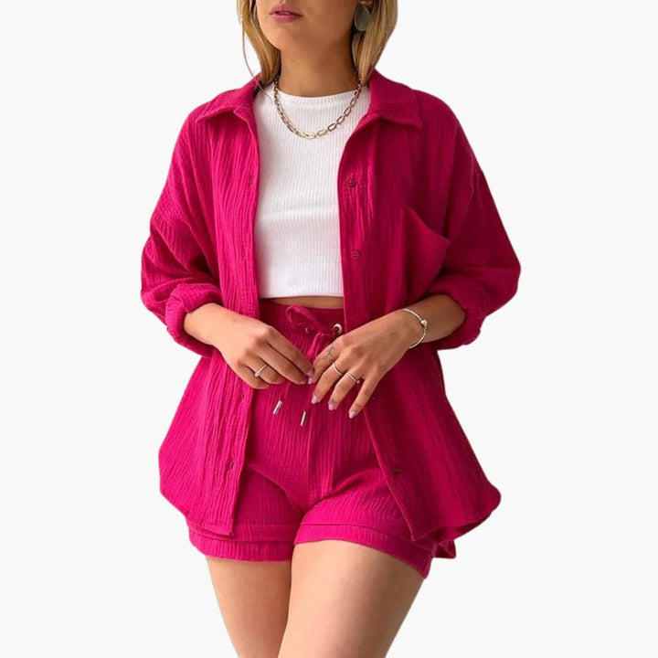 Modern women's matching outfit: a three-piece set with a stylish shirt, crop top, and high-waist shorts.
