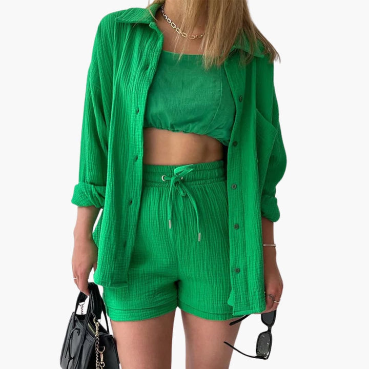 Chic women's three-piece set, perfect for vacation, includes a relaxed shirt, crop top, and high-waist shorts.