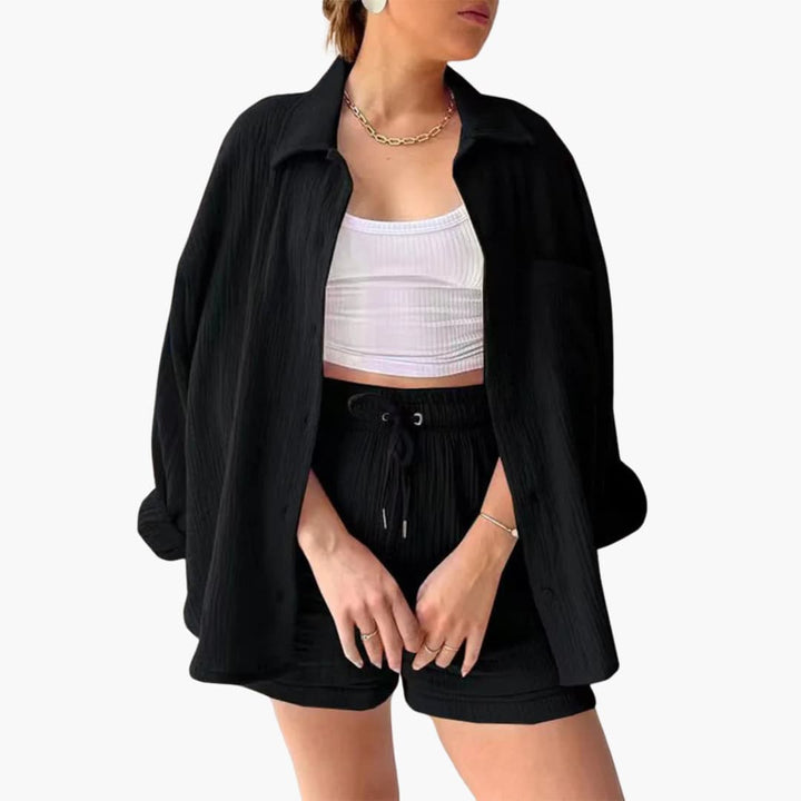 Full length view of women's three-piece casual set, featuring a shirt, crop top, and high-waist shorts.