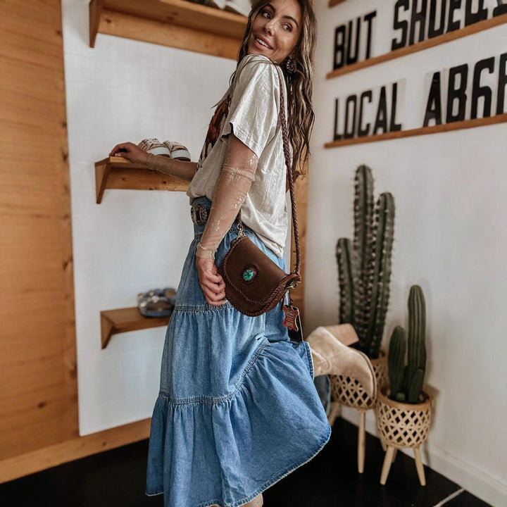 Casual women's tiered maxi skirt in a versatile style, designed with a chic button front and fashionable raw hem.