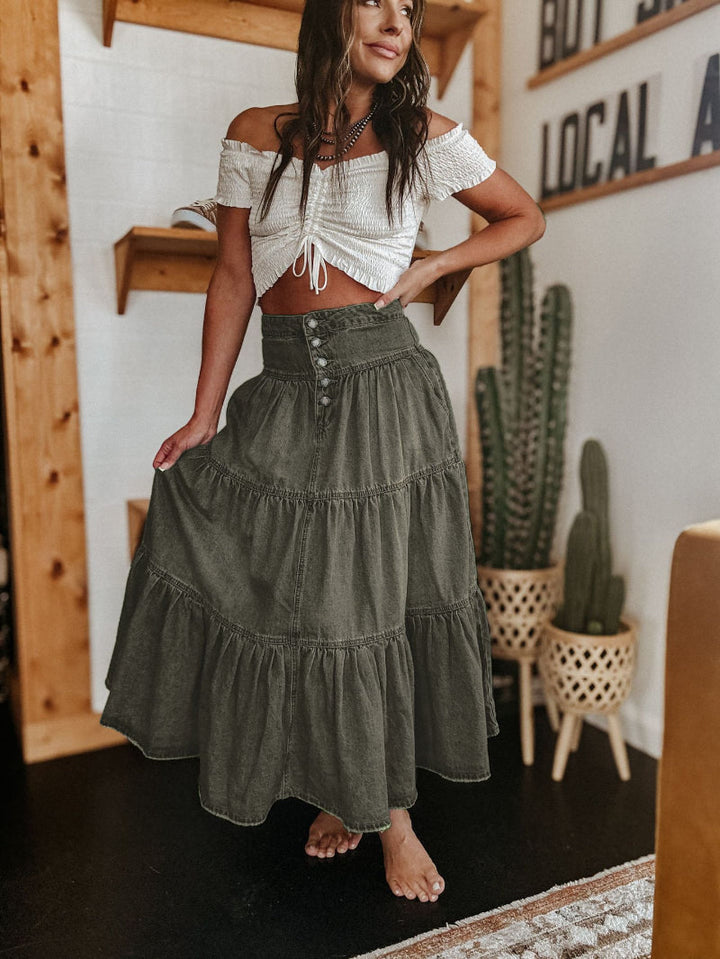 Women's tiered maxi skirt modeled, highlighting the casual flowy fit, button front, & trendy raw hem. Versatile style.