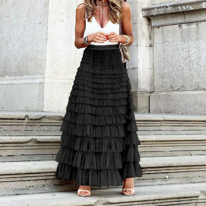 Comfortable women's tiered maxi skirt with elastic high waist. Elegant, long, and flowy for events.